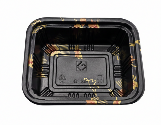 Black plastic food container with floral patterns on a white background
