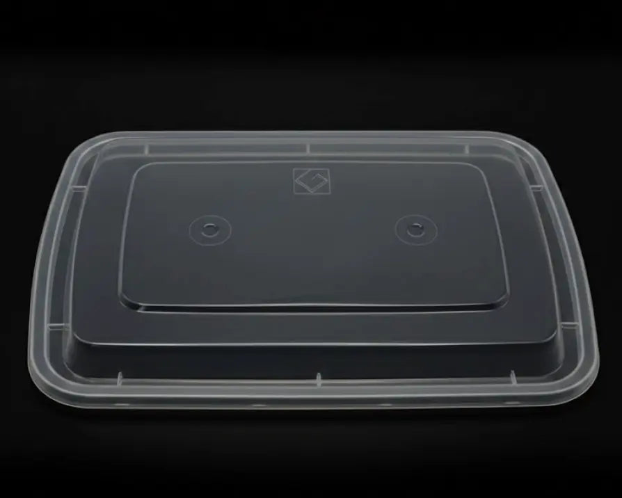 Clear plastic container with a black lid on a black background