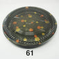 A round black plastic party tray with a flower pattern design.