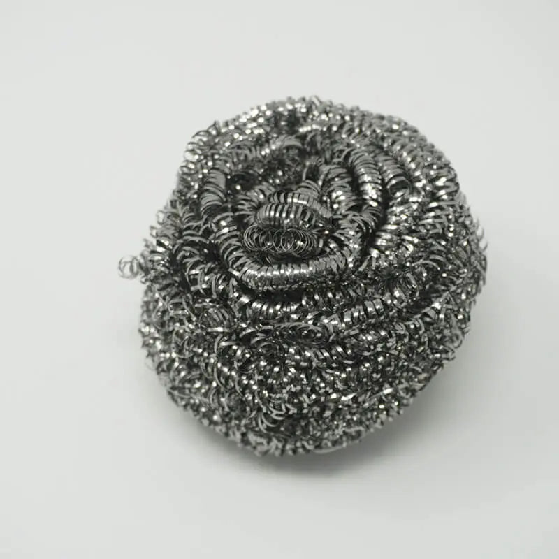 Round silver-colored metal scrubber made of coiled strands