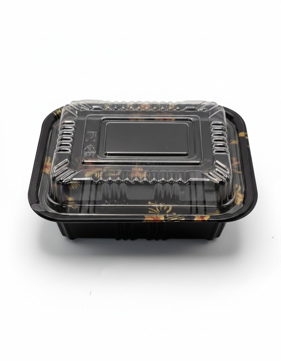 Black plastic food container with transparent lid on a white background