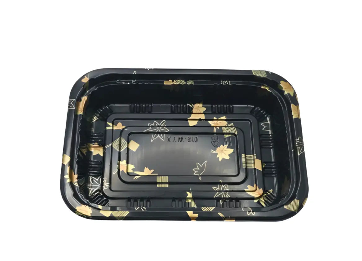 Black plastic tray with gold floral patterns on a white background