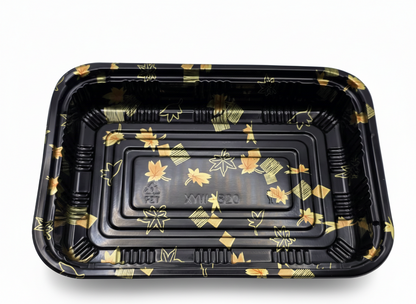 Black plastic tray with gold floral patterns on a white background