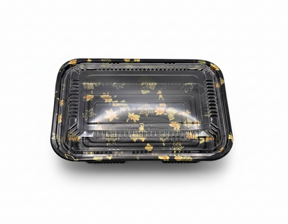 Black plastic food container with floral design on a white background