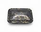 Black plastic food container with floral design on a white background