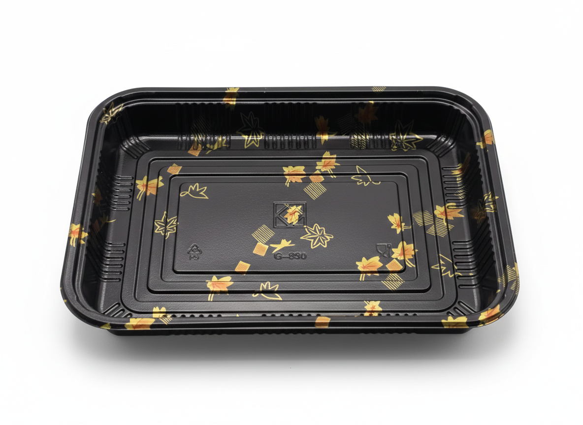 Black plastic tray with gold floral patterns on a white background