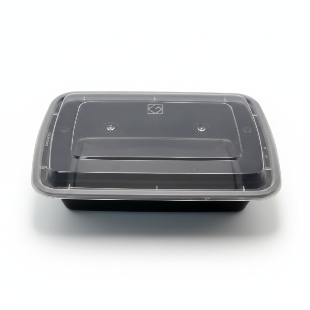 Black food container with clear lid on a white background